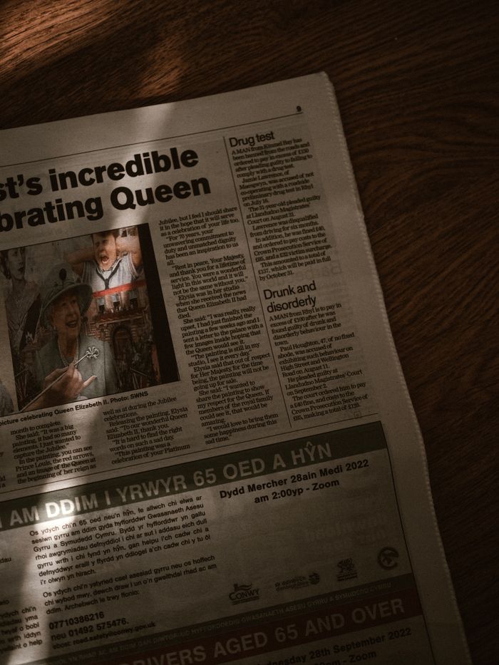 Crafting Captivating Headlines: Your awesome post title goes here Artistic shot of a newspaper featuring editorial content with light and shadow effects.