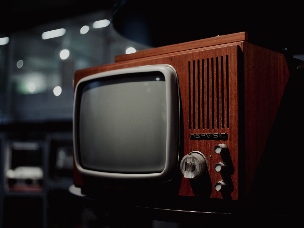 A classic vintage CRT television captured artfully in a dimly lit room, exuding retro charm.